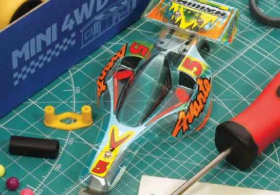 Custom painted Mini 4WD body being assembled on a cutting mat